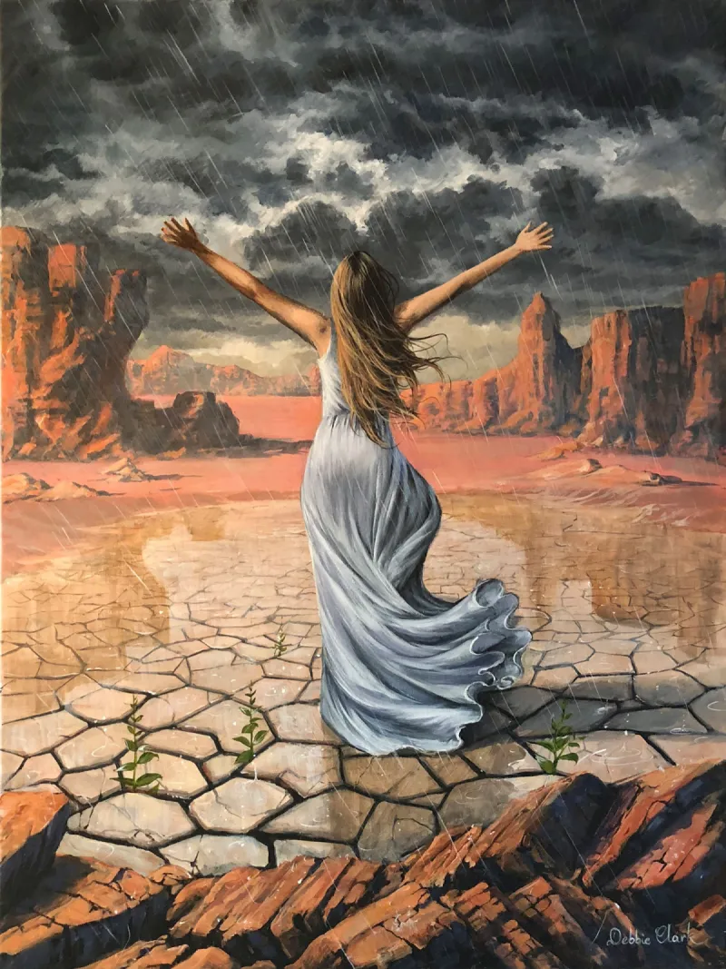 Joyful Spirit: A woman standing, facing away throwing her arms up in joy of the rain on a parched land.